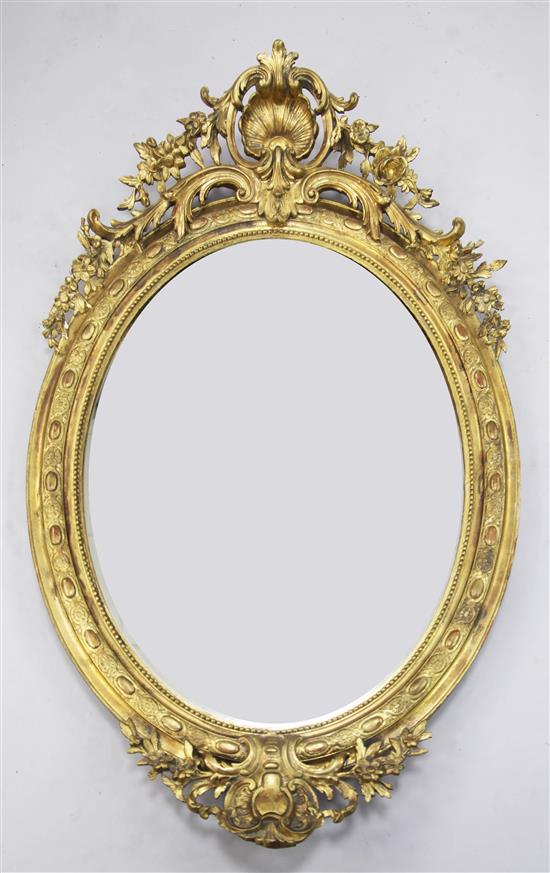 A 19th century French oval gilt gesso wall mirror, 4ft 8in. x 2ft 11in.